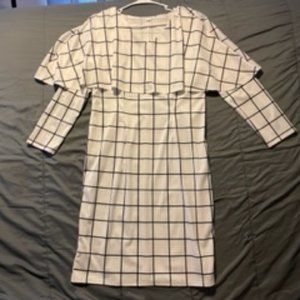 White dress with black vertical/horizontal stripes & shoulder cape